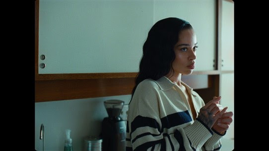 Ella Mai in the Might Just music video, sitting in a car in a scene referencing Waiting to Exhale.
